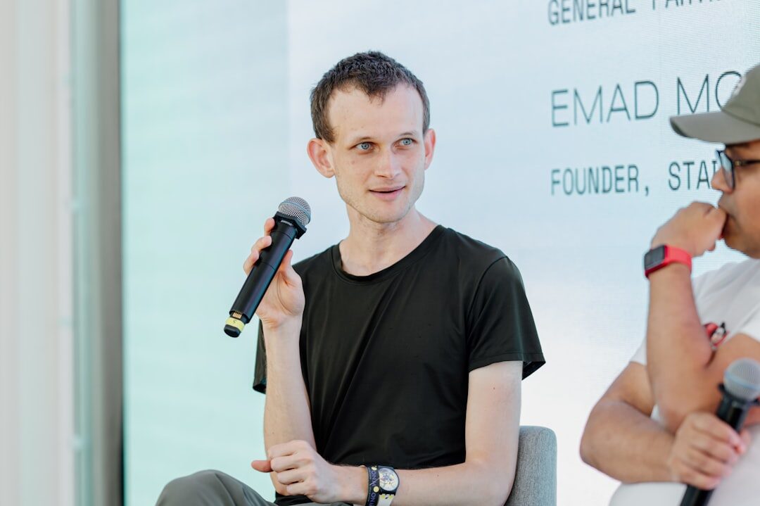 Moderator speaking into a microphone during a panel discussion